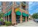 Gus's Fried Chicken storefront with green awnings and brick facade, offering a welcoming entrance at 476 Springer Nw Bnd, Marietta, GA 30060