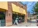 Charming Honeysuckle Gelato & Bakery storefront with yellow awning and sidewalk dining at 476 Springer Nw Bnd, Marietta, GA 30060