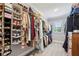 Organized walk-in closet with ample storage, featuring shelving, hanging racks, and a window for natural light at 476 Springer Nw Bnd, Marietta, GA 30060