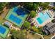 An aerial shot showcases the pool and tennis courts surrounded by beautiful landscaping and trees at 478 Vinings Estates Se Dr # B02, Smyrna, GA 30126