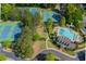 An aerial view of the community pool, clubhouse, tennis courts, and mature trees around the property at 478 Vinings Estates Se Dr # B02, Smyrna, GA 30126