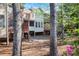 View of back of house with two levels of decks and mature trees at 478 Vinings Estates Se Dr # B02, Smyrna, GA 30126