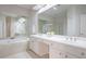 Bright bathroom features double vanity, soaking tub, and large mirror, creating a relaxing and functional space at 478 Vinings Estates Se Dr # B02, Smyrna, GA 30126