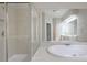 Bright bathroom featuring a soaking tub and a glass shower at 478 Vinings Estates Se Dr # B02, Smyrna, GA 30126