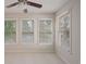 Sunlit bedroom featuring large windows with backyard views, fan and cozy carpet, creating a serene space at 478 Vinings Estates Se Dr # B02, Smyrna, GA 30126