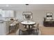 Bright dining area with marble table, modern chandelier, and open access to the kitchen at 478 Vinings Estates Se Dr # B02, Smyrna, GA 30126