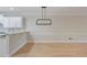 Minimalist dining room area with hardwood floors, a modern light fixture, and ample natural light at 478 Vinings Estates Se Dr # B02, Smyrna, GA 30126