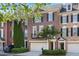 Charming brick townhome featuring black shutters, a two-car garage, and manicured landscaping at 478 Vinings Estates Se Dr # B02, Smyrna, GA 30126