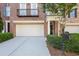Exterior view showcasing two-car garage and well-maintained landscaping with green shrubbery at 478 Vinings Estates Se Dr # B02, Smyrna, GA 30126