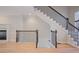 Open hallway featuring hardwood floors, a staircase with a decorative banister, and a fireplace at 478 Vinings Estates Se Dr # B02, Smyrna, GA 30126