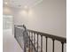 Hallway with carpet, stairs and decorative railing and a view into another room at 478 Vinings Estates Se Dr # B02, Smyrna, GA 30126