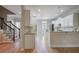 Bright kitchen with granite countertops, white cabinets, stainless steel appliances, and hardwood floors at 478 Vinings Estates Se Dr # B02, Smyrna, GA 30126