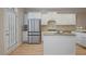 Modern kitchen features stainless steel refrigerator, white cabinets, granite countertops and hardwood floors at 478 Vinings Estates Se Dr # B02, Smyrna, GA 30126