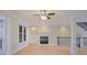 Spacious living room with hardwood floors, fireplace, built-in shelves, and staircase access at 478 Vinings Estates Se Dr # B02, Smyrna, GA 30126