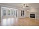 Bright living room with hardwood floors, fireplace, built-in shelves, and a wall of windows at 478 Vinings Estates Se Dr # B02, Smyrna, GA 30126