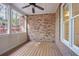 Screened-in porch with brick wall and wood floors is great for entertaining at 478 Vinings Estates Se Dr # B02, Smyrna, GA 30126