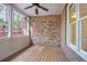 Charming screened porch with brick accents, wood floors, and natural light at 478 Vinings Estates Se Dr # B02, Smyrna, GA 30126