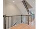 Elegant staircase featuring wood floors, black metal balusters, and dark wood handrail, providing a classic design at 478 Vinings Estates Se Dr # B02, Smyrna, GA 30126