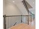 Hardwood staircase with dark railing and plenty of light at 478 Vinings Estates Se Dr # B02, Smyrna, GA 30126