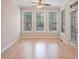 Sun room with hardwood floors is surrounded by large windows at 478 Vinings Estates Se Dr # B02, Smyrna, GA 30126