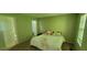 Cozy bedroom featuring a white bedspread and ample natural light from the window at 728 Brittany Ct, Stone Mountain, GA 30083