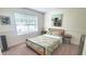 Comfortable bedroom with neutral walls, carpet, and a large window, offering a relaxing and bright space at 728 Brittany Ct, Stone Mountain, GA 30083