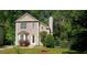Inviting two-story home featuring a well-maintained lawn, complemented by lush greenery and mature trees at 728 Brittany Ct, Stone Mountain, GA 30083