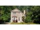 Charming two-story home with a manicured lawn and mature trees providing shade and privacy at 728 Brittany Ct, Stone Mountain, GA 30083