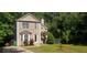 Charming two-story home with a well-maintained front yard and a variety of trees and shrubs at 728 Brittany Ct, Stone Mountain, GA 30083