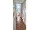 Hallway with a wood floor leading to the bathroom with a view of vanity and toilet at 728 Brittany Ct, Stone Mountain, GA 30083