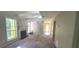 Bright living room with a fireplace, beams, and large windows offering ample natural light and an open staircase at 728 Brittany Ct, Stone Mountain, GA 30083