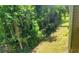 Lush ground cover between chain link fence and siding of the house, offering privacy and greenery at 728 Brittany Ct, Stone Mountain, GA 30083