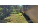 Ground level shot of chain link fence marking the property line with ground cover between fence and foundation at 728 Brittany Ct, Stone Mountain, GA 30083