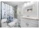Bathroom featuring a shower-tub combo with stylish tiling, decorative floor tiles, and a single sink vanity at 3180 Spring St, South Fulton, GA 30349