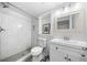Bathroom with a tiled walk-in shower, patterned floor tiles, and a single sink vanity at 3180 Spring St, South Fulton, GA 30349