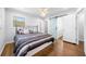 Bedroom featuring hardwood floors, a barn door, and great natural light from the window at 3180 Spring St, South Fulton, GA 30349