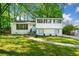 Charming two-story home with a brick facade, wooden shutters, landscaped yard, and a welcoming light blue front door at 3180 Spring St, South Fulton, GA 30349
