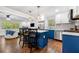 Contemporary kitchen boasts stainless steel appliances, sleek countertops, and stylish blue cabinetry for a modern look at 3180 Spring St, South Fulton, GA 30349