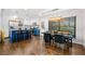 Open kitchen featuring an island with barstool seating, stainless appliances, and modern lighting at 3180 Spring St, South Fulton, GA 30349