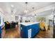 Open kitchen with white countertops, blue cabinets, and stainless appliances offers modern convenience and style at 3180 Spring St, South Fulton, GA 30349
