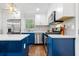 Bright, open kitchen features a central island with bar stools, connecting seamlessly to the living area for easy entertaining at 3180 Spring St, South Fulton, GA 30349
