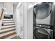 Convenient laundry area with washer and dryer; open to a staircase and bathroom at 3180 Spring St, South Fulton, GA 30349