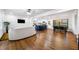 Open-concept living area features hardwood floors, recessed lighting and seamlessly connects to the modern kitchen and dining area at 3180 Spring St, South Fulton, GA 30349