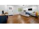 Bright living room features gleaming hardwood floors, a cozy sofa and neutral color scheme, creating a welcoming atmosphere at 3180 Spring St, South Fulton, GA 30349