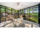 Cozy screened-in porch with wicker seating and ceiling fan, perfect for outdoor enjoyment at 3180 Spring St, South Fulton, GA 30349