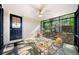 Relaxing screened-in porch with wicker seating, fan, and view of the wooded backyard at 3180 Spring St, South Fulton, GA 30349
