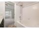 Bathroom with a white tiled tub and shower, with view into the light gray bedroom at 1310 Kilmington Ct, Alpharetta, GA 30009