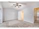 Large bedroom featuring plush carpet, neutral walls, and an ensuite bathroom at 1310 Kilmington Ct, Alpharetta, GA 30009