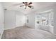 Spacious bedroom featuring soft gray carpet, large windows, and a ceiling fan at 1310 Kilmington Ct, Alpharetta, GA 30009