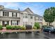 Inviting townhouse showcasing a bay window, front landscaping, and dedicated parking spot in a residential area at 1310 Kilmington Ct, Alpharetta, GA 30009